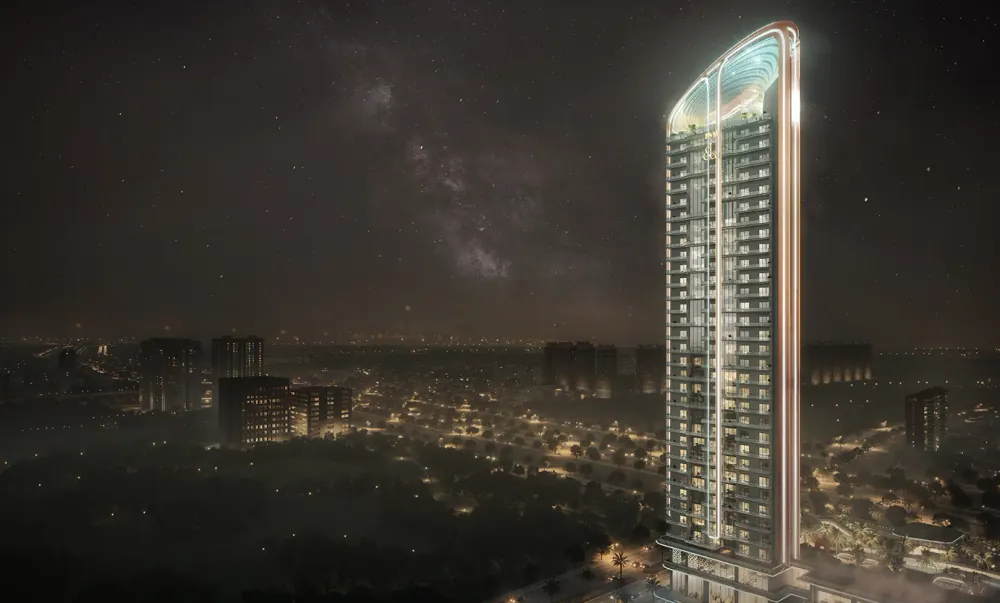 Illuminated Jacob & Co residential tower against the Noida night skyline